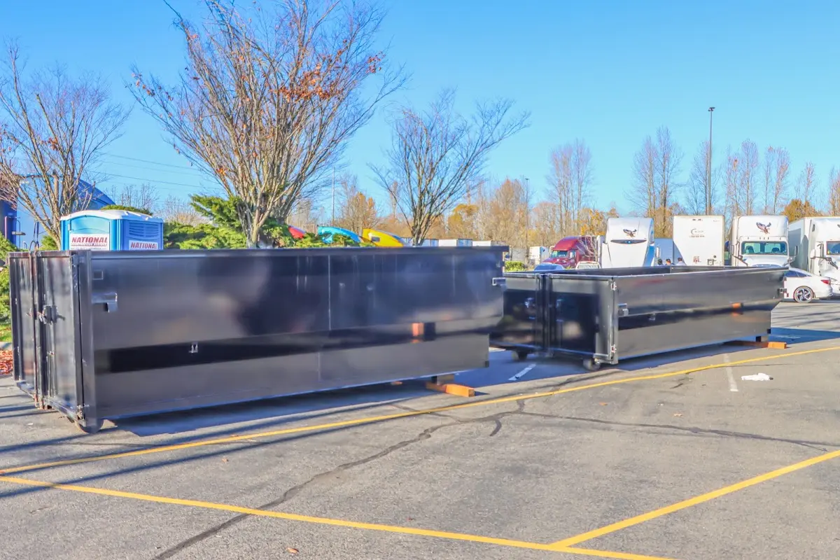 Professional dumpster rental service with roll-off container on residential driveway in Dahlonega